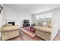 Bright living room featuring a fireplace, large windows, and neutral decor at 5655 Lighthouse Dr, Brownsburg, IN 46112