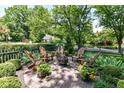 Inviting backyard fire pit area with Adirondack chairs and mature greenery at 5681 Carrollton Ave, Indianapolis, IN 46220