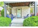 Inviting front porch featuring stone facade and a cozy seating area at 6045 Haverford Ave, Indianapolis, IN 46220
