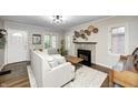 Cozy living room with a fireplace, neutral paint, and hardwood floors at 6045 Haverford Ave, Indianapolis, IN 46220