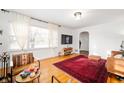 Bright living room with hardwood floors, large windows, neutral walls and stylish decor at 6640 E Washington St, Indianapolis, IN 46219