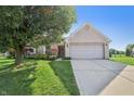 Beautiful home exterior with well-manicured lawn, mature trees, and a two-car garage at 7456 Jack Pine Ct, Avon, IN 46123