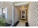 Welcoming brick porch with a dark wood door and decorative outdoor lighting at 7456 Jack Pine Ct, Avon, IN 46123