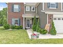 Inviting front porch with decorative plants, white gravel, and a charming 'Hello Sunshine' sign at 7603 Merrick Dr, Brownsburg, IN 46112