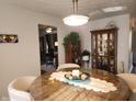 Sunlit dining area with modern light fixture, glass-top table, and stylish decor at 7870 E County Road 150 S, Avon, IN 46123