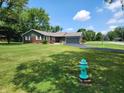 Quaint single-story home with a lush green lawn and tree-lined surroundings at 7870 E County Road 150 S, Avon, IN 46123