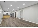 Open concept living space featuring wood floors, recessed lighting, and kitchen with stainless steel appliances at 802 N Tuxedo St, Indianapolis, IN 46201