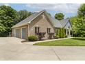 A beautiful home featuring brick accents, a three-car garage, and manicured landscaping at 815 Copperfield Ln, Danville, IN 46122