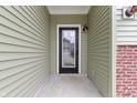 Close-up of front door with glass accents and neutral colored siding at 8355 Fieldfare Way, Indianapolis, IN 46237