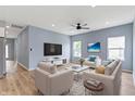 Bright living room with recessed lighting, ceiling fan, and comfortable seating arrangement at 8355 Fieldfare Way, Indianapolis, IN 46237