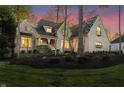 Elegant two-story home with brick exterior, inviting porch, and professional landscaping at 9399 Irishmans Run Ln, Zionsville, IN 46077