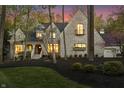 Stunning brick home with professional landscaping, elegant porch, and warm lighting at 9399 Irishmans Run Ln, Zionsville, IN 46077