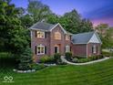 Charming brick home with manicured landscaping and a lush green lawn at 9703 Fortune Dr, Fishers, IN 46037