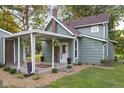 Home exterior featuring a covered awning, well-kept lawn, and tasteful landscaping at 106 N Blake St, Sheridan, IN 46069