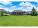 Expansive backyard featuring lush green lawn, mature trees, and a screened-in porch perfect for outdoor relaxation at 1135 Maclaren Ct, Franklin, IN 46131