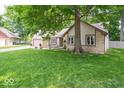 Well-maintained ranch home with a stone facade, mature trees, and green lawn at 1304 Old Hickory Cir, Greenwood, IN 46142