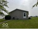 Side view of a well-maintained ranch home featuring a grassy lawn at 135 Sunset Ct, Cicero, IN 46034