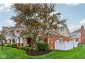 View of the home's exterior, featuring a fenced yard and a tree providing shade, perfect for outdoor relaxation at 15528 Bowie Dr, Westfield, IN 46074