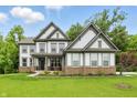 Inviting two-story home with a well-maintained lawn and professionally landscaped front yard at 16244 Perrault Ct, Fishers, IN 46040
