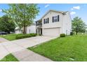 Well-kept two story house with a concrete driveway, green grass and landscaping at 1903 Windy Hill Ln, Indianapolis, IN 46239