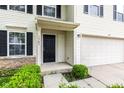 Up close view of the front door and garage on this two-story house at 1903 Windy Hill Ln, Indianapolis, IN 46239