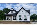 An in-progress new construction home featuring a black roof, large windows, and a welcoming front porch at 1960 Delp Ct, Avon, IN 46123