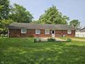 The house features a simple backyard and has a brick exterior with several windows that offer views at 2017 Schwier Ct, Indianapolis, IN 46229