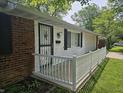 Home showing the front porch with white railing, brick exterior, and decorative iron security door at 2017 Schwier Ct, Indianapolis, IN 46229