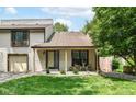 Charming townhome exterior featuring a cozy front patio and lush green lawn at 2433 Hideaway S Dr, Indianapolis, IN 46268