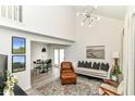 Spacious living room with vaulted ceilings, slider doors, and a decorative rug at 2433 Hideaway S Dr, Indianapolis, IN 46268