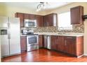 Well-equipped kitchen with stainless steel appliances, modern cabinets, and mosaic backsplash at 2434 Harvest Moon Dr, Greenwood, IN 46143