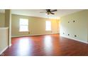 Inviting living room featuring plush carpeting, bright windows, and a modern ceiling fan at 2434 Harvest Moon Dr, Greenwood, IN 46143