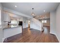 Open-concept living area with hardwood floors and staircase, perfect for entertaining at 244 W 31St St, Indianapolis, IN 46208