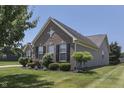 Stylish home showcasing brick and vinyl siding, a well-kept lawn, and attractive curb appeal at 2502 Colinbrook Pkwy, Greenwood, IN 46143