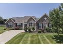 Attractive brick home featuring manicured lawn, tidy shrubbery, and symmetrically placed windows at 2502 Colinbrook Pkwy, Greenwood, IN 46143