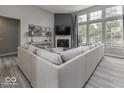 Bright living room featuring a corner fireplace and large windows for natural light at 2502 Colinbrook Pkwy, Greenwood, IN 46143