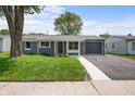 Single story home featuring a well-kept lawn, siding, and an attached garage, perfect for first-time homebuyers at 2537 N Boehning St, Indianapolis, IN 46219