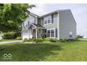 A view of a lovely home with neat landscaping, a spacious lawn, and a driveway at 2786 Longleaf Dr, Greenwood, IN 46143
