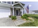 Inviting home entrance featuring well-kept landscaping, stone accents, and an American flag at 2786 Longleaf Dr, Greenwood, IN 46143