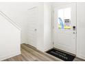 Bright foyer with hardwood floors, white trim, and a view of the front door at 2920 Woods Edge Dr, Greenwood, IN 46143