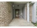 Covered entryway with brick accents, a welcoming door, and decorative plants at 3714 Turfway Ct, Indianapolis, IN 46228