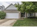 Inviting home featuring brick and siding, an attached garage, and mature landscaping at 3714 Turfway Ct, Indianapolis, IN 46228