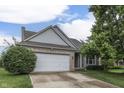 Charming home with a brick facade, attached garage, and well-maintained lawn at 3714 Turfway Ct, Indianapolis, IN 46228