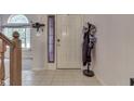 Foyer featuring tile floors, coat rack, and natural light from the nearby window at 3714 Turfway Ct, Indianapolis, IN 46228