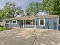 Charming single-story home with a large driveway and well-maintained lawn at 4020 N Mitthoefer Rd, Indianapolis, IN 46235