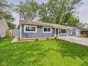 Charming single-story home with a well-maintained green lawn at 4020 N Mitthoefer Rd, Indianapolis, IN 46235