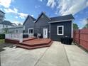 Well-kept backyard featuring a spacious deck, concrete patio, and tidy landscaping, excellent for outdoor living at 421 W Hendricks St, Shelbyville, IN 46176
