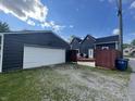 View of backyard featuring garage and fenced yard with an access gate to the backyard and home at 421 W Hendricks St, Shelbyville, IN 46176