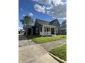 Attractive two-story home with a welcoming front porch, manicured lawn, and mature trees for comfortable living at 421 W Hendricks St, Shelbyville, IN 46176