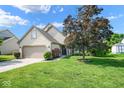 Inviting home with a manicured lawn, flowering bushes, and a two-car garage, perfect for Gathering living at 4342 Sequoia Ct, Greenwood, IN 46143